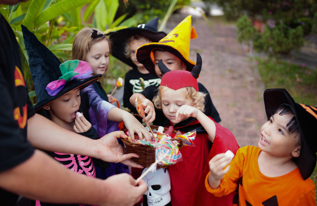 A friendship group dressed-up trick or treating at a neighbour's house