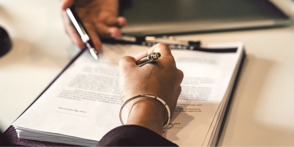 a woman signing a contract of employment